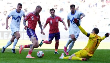 Slovenia goalkeeper Jan Oblak saves at the feet of Scotland's Oli McBurnie