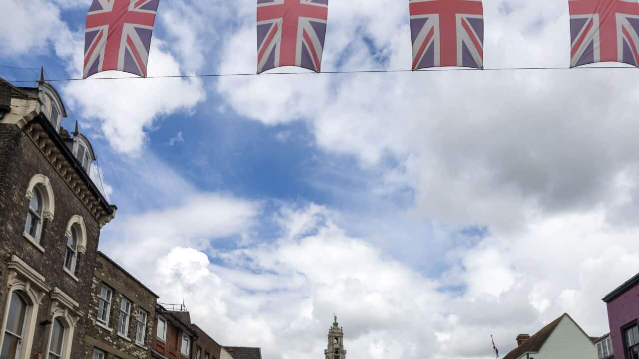 Union Jack bunting flags in a line strung across High Street in town center of Colchester, Essex, England, UK