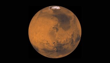 spacecraft photo of mars in deep space, showing ice caps at its north pole
