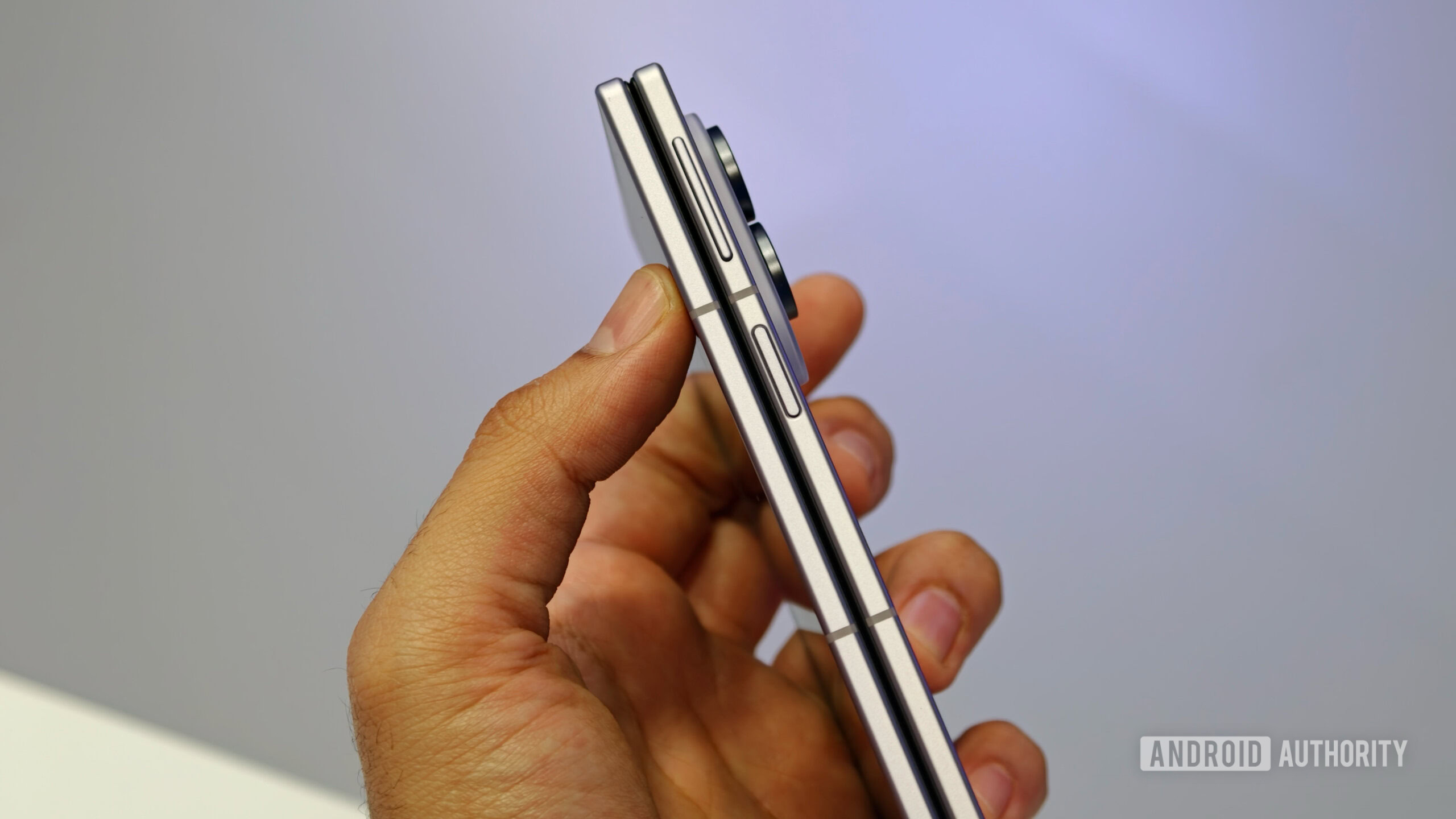 Side profile view of the folded Samsung Galaxy Z Fold 8 held in hand, highlighting its thin frame, power button, and volume rocker