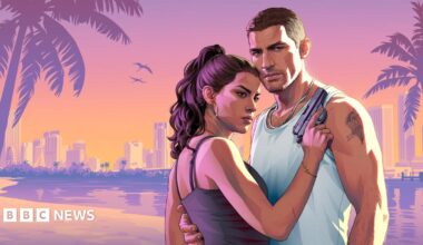 A promotional image from the game GTA 6 featuring the two main characters, Jason and Lucia. He is wearing a white vest and has a crewcut and a tattoo on his left bycep. She is facing him with a gun in her right hand.