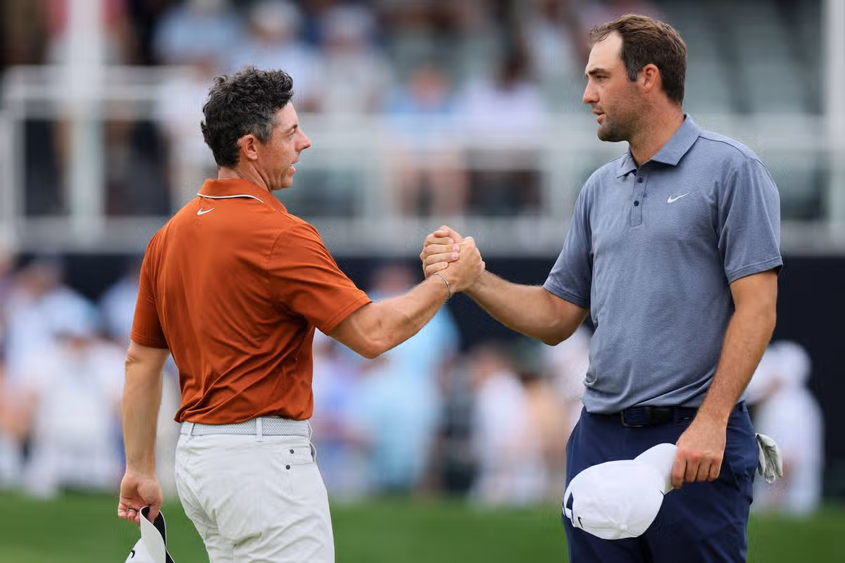 Rory McIlroy of Northern Ireland, left, shakes hands with Scottie Scheffler of the United States on the 18th hole green after finishing the second round of the PGA Championship at Quail Hollow Country Club on May 16, 2025 in Charlotte, North Carolina