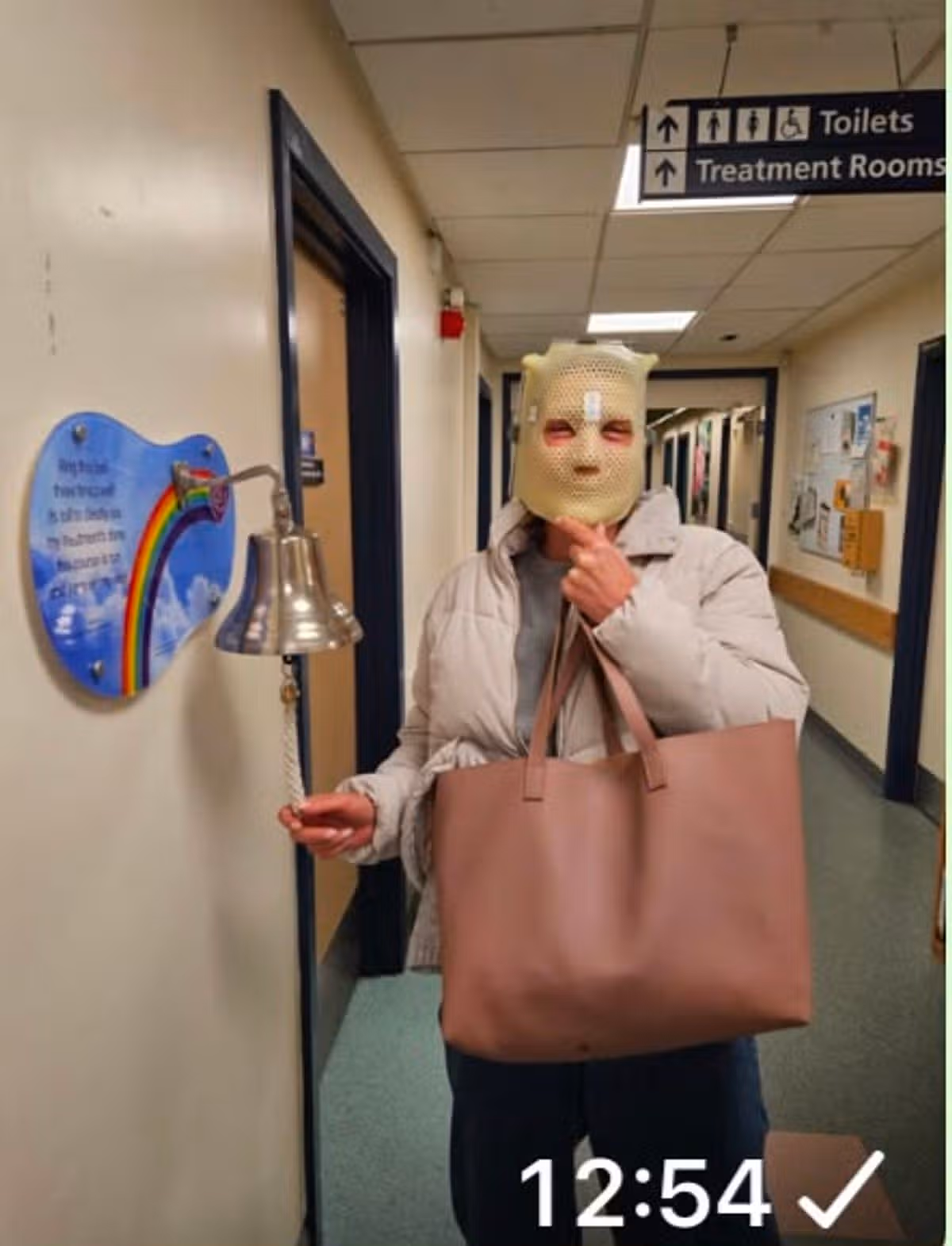 Charlotte Curnow ringing the bell following her treatments