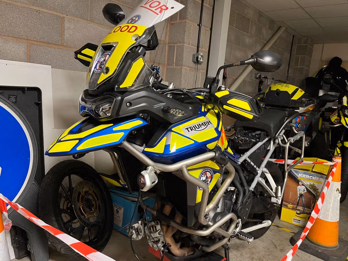 One of the Devon Freewheeler bikes temporarily off the road while its volunteer mechanic awaits new parts.