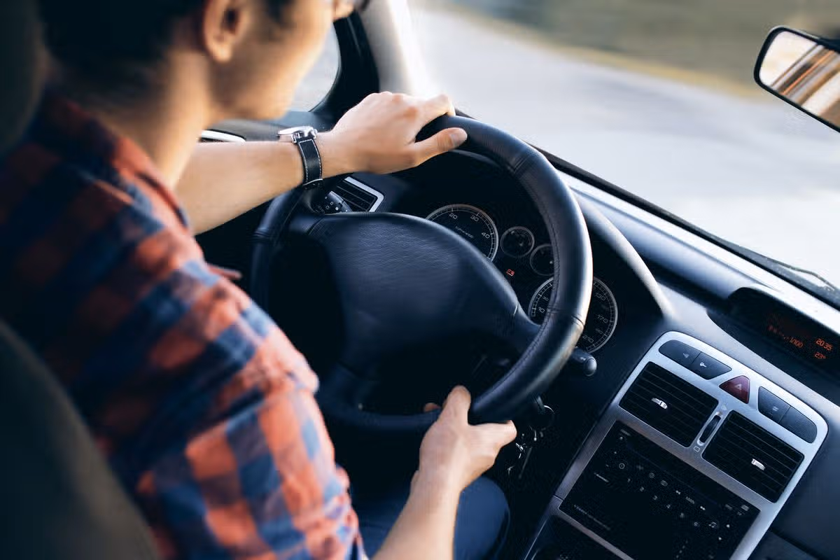 Generic driving learner passenger young man steering wheel