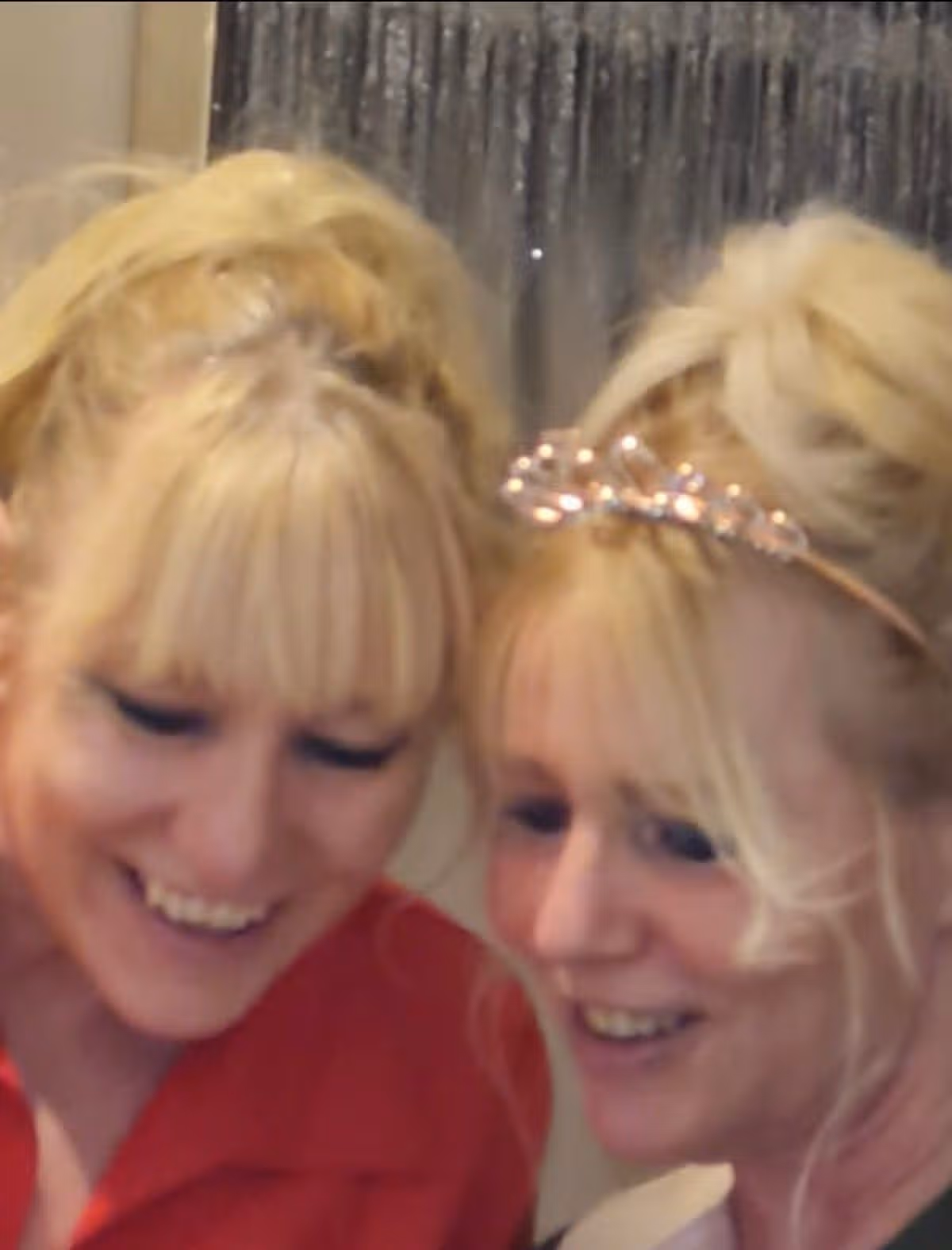 Two blonde-haired women looking down