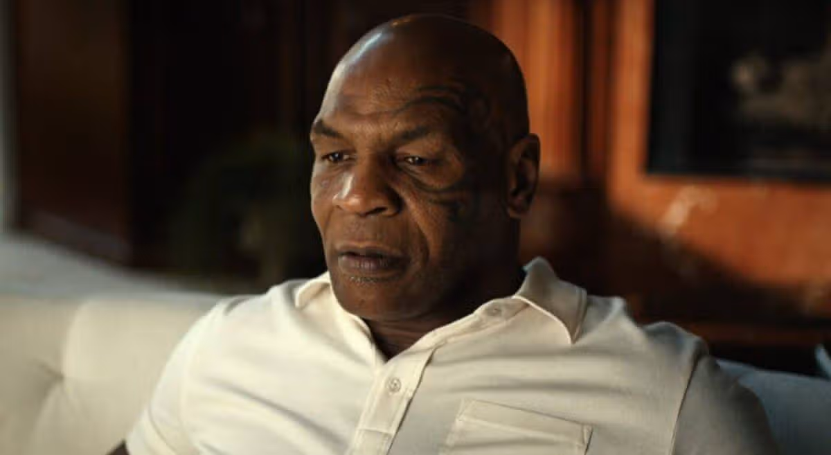 A man in a white shirt looks emotional