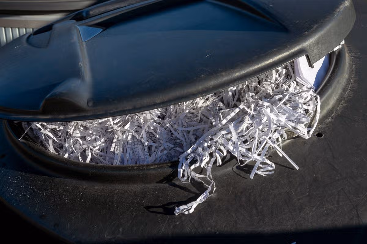 recycling bin full of shredded paper