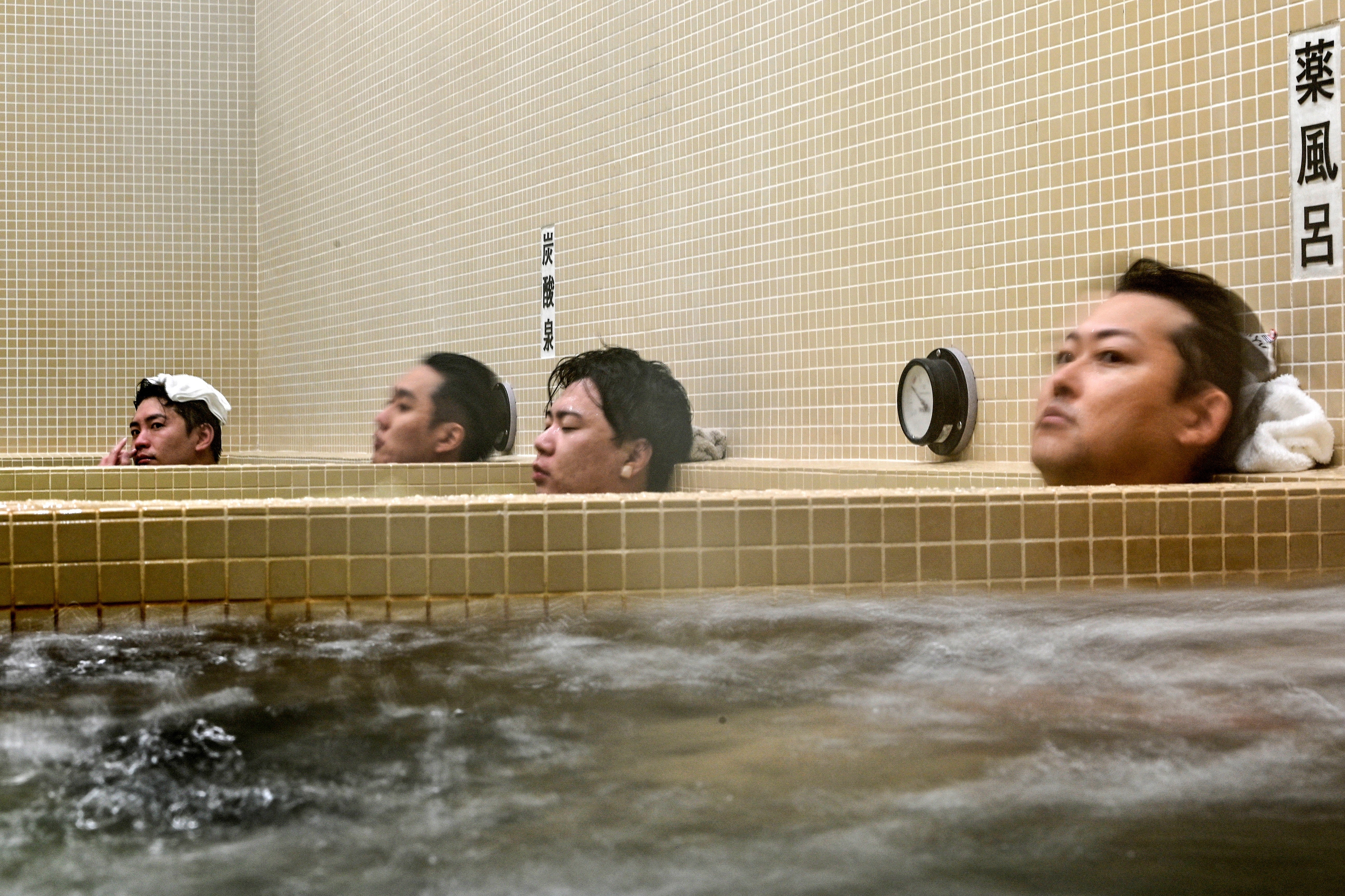 Customers relaxing in a hot bath at Koganeyu