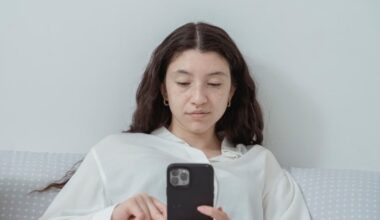 Woman looking at her phone with a poker face