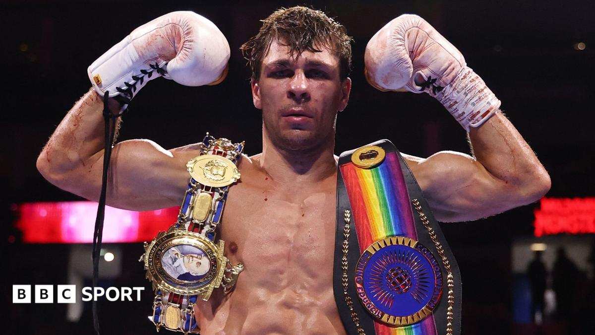 Constantin Ursu poses with a belt on either shoulder following a fight