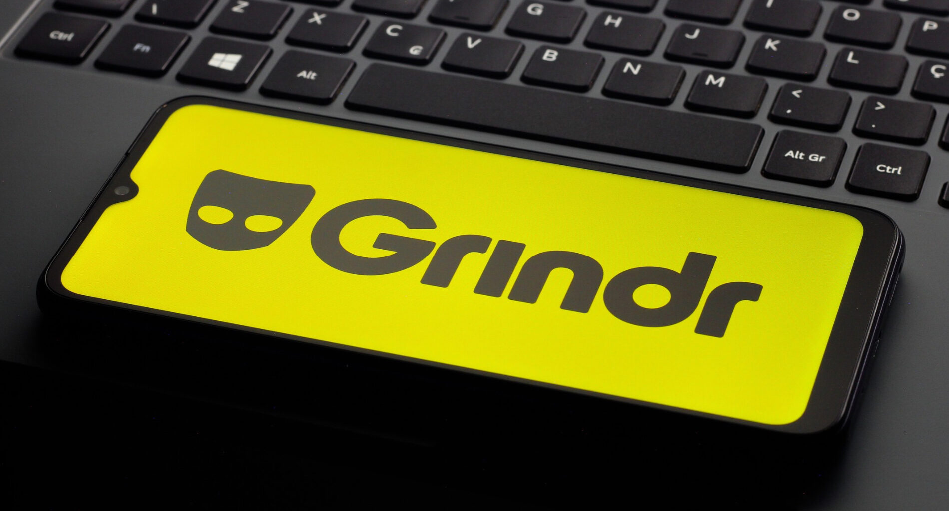 In this photo illustration, the Grindr logo is seen displayed on a smartphone screen