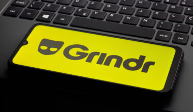In this photo illustration, the Grindr logo is seen displayed on a smartphone screen