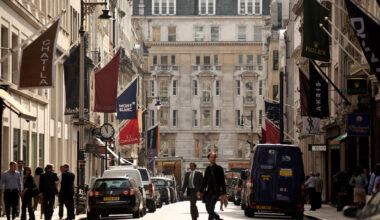 Mayfair street view showcasing luxury shops, bustling activity, and elegant architecture in a prominent business district