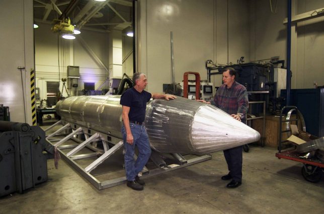 Al Weimorts, creator of the GU43/B Massive Ordnance Air Blast bomb, known colloquially as the Mother of All Bombs or MOAB, with Joseph Fellenz (left), lead model maker, looking over the prototype of the bomb before it was painted and tested, 2008. Image courtesy US DoD. (Photo via Smith Collection/Gado/Getty Images).