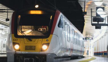 A Class 720 Aventra train departing a station