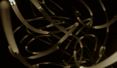 a gif of details of a suspended LED light sculpture with luminescence moving through undulating tubes