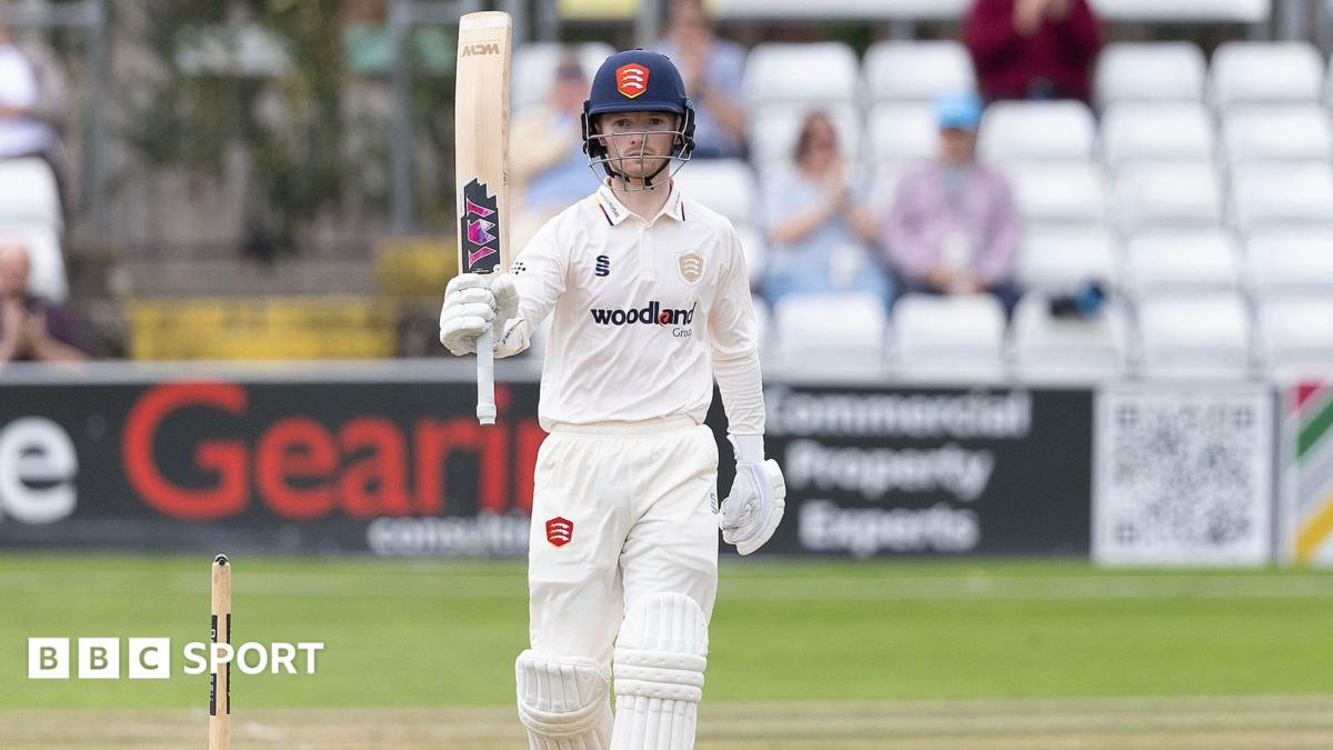 George Bell raising his bat after scoring a half-century for Essex