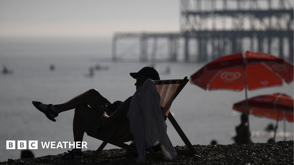 Man sits in deckchair on Brighton beach during early September heatwave