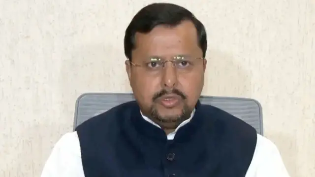 BJP President Nitin Nabin wearing a sleeveless jacket over a white Kurta sits on a chair while addressing a press conference in Delhi on 10 October 2026.