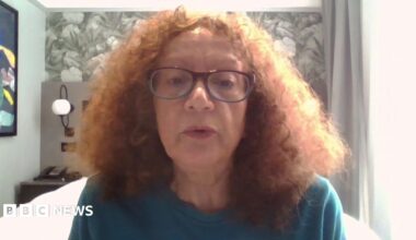 Vivien Lichtenstein appears on camera, wearing glasses, in a bedroom.