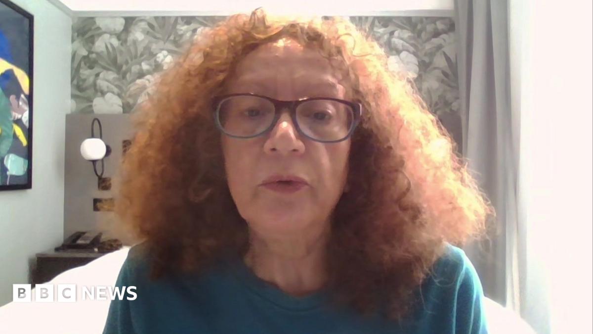 Vivien Lichtenstein appears on camera, wearing glasses, in a bedroom.