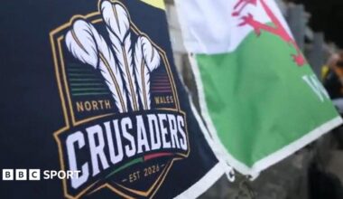 North Wales Crusaders flag alongside Welsh dragon flag