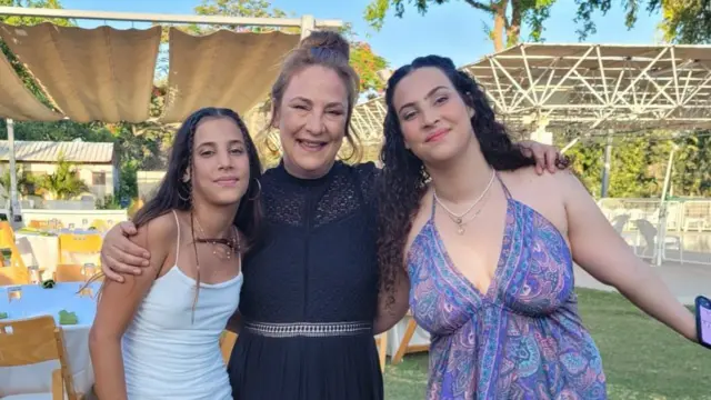 Yahel Sharabi (L) Noiya (R), and their mother Lianne (C) smile in a picture