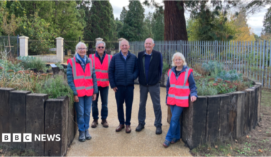 A group of people in a memorial garden.
