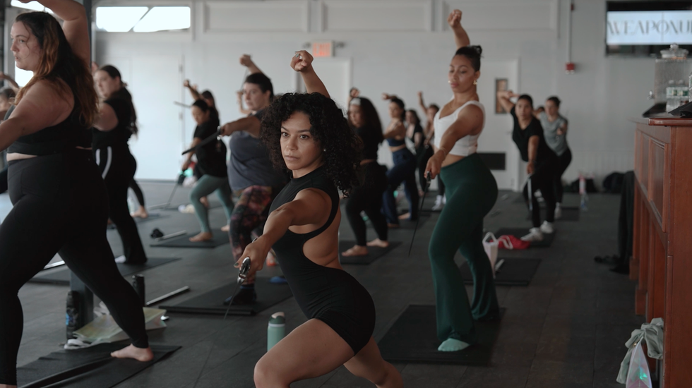 WeaponUp members doing a sword yoga class together