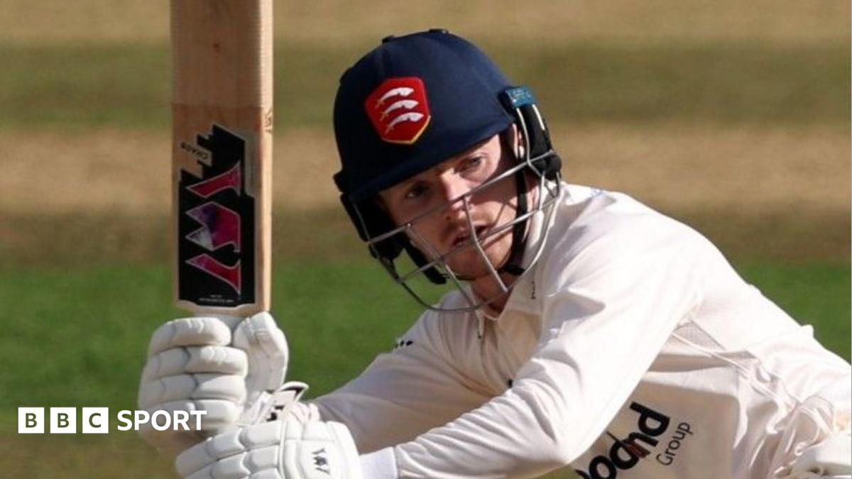 George Bell, wearing an Essex Cricket helmet, swings his bat during a match.