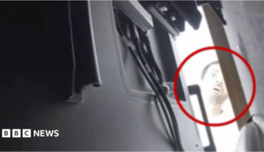 A still from a CCTV image of the alleged suspect Abdulrahman Alfozan peering behind the back of a TV in a room