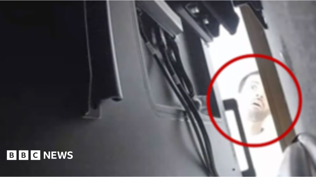 A still from a CCTV image of the alleged suspect Abdulrahman Alfozan peering behind the back of a TV in a room