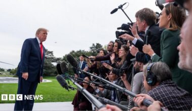 Donald Trump speaks to a large media scrum
