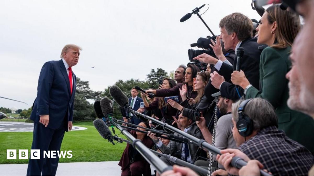 Donald Trump speaks to a large media scrum