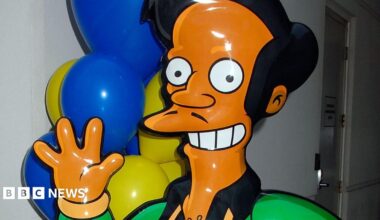 A mocked-up life size version of the Simpsons character Apu, seen smiling and waving. Picture taken in 2007