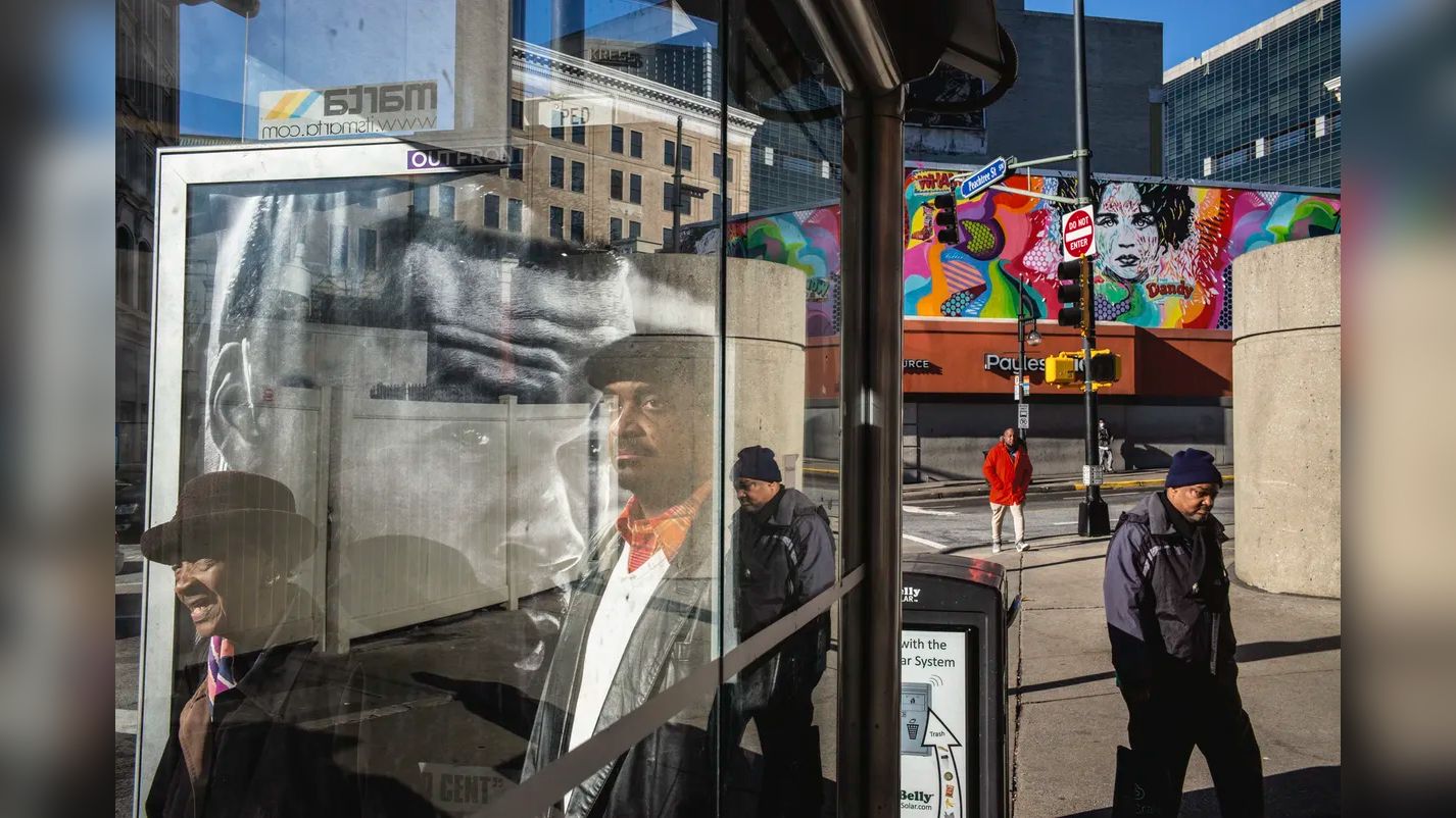 A woman laughs behind glass, rainbows arc through a sprinkler and a marching band waits by the sea: Alex Webb’s camera photographs an America that's busy, bright and connected