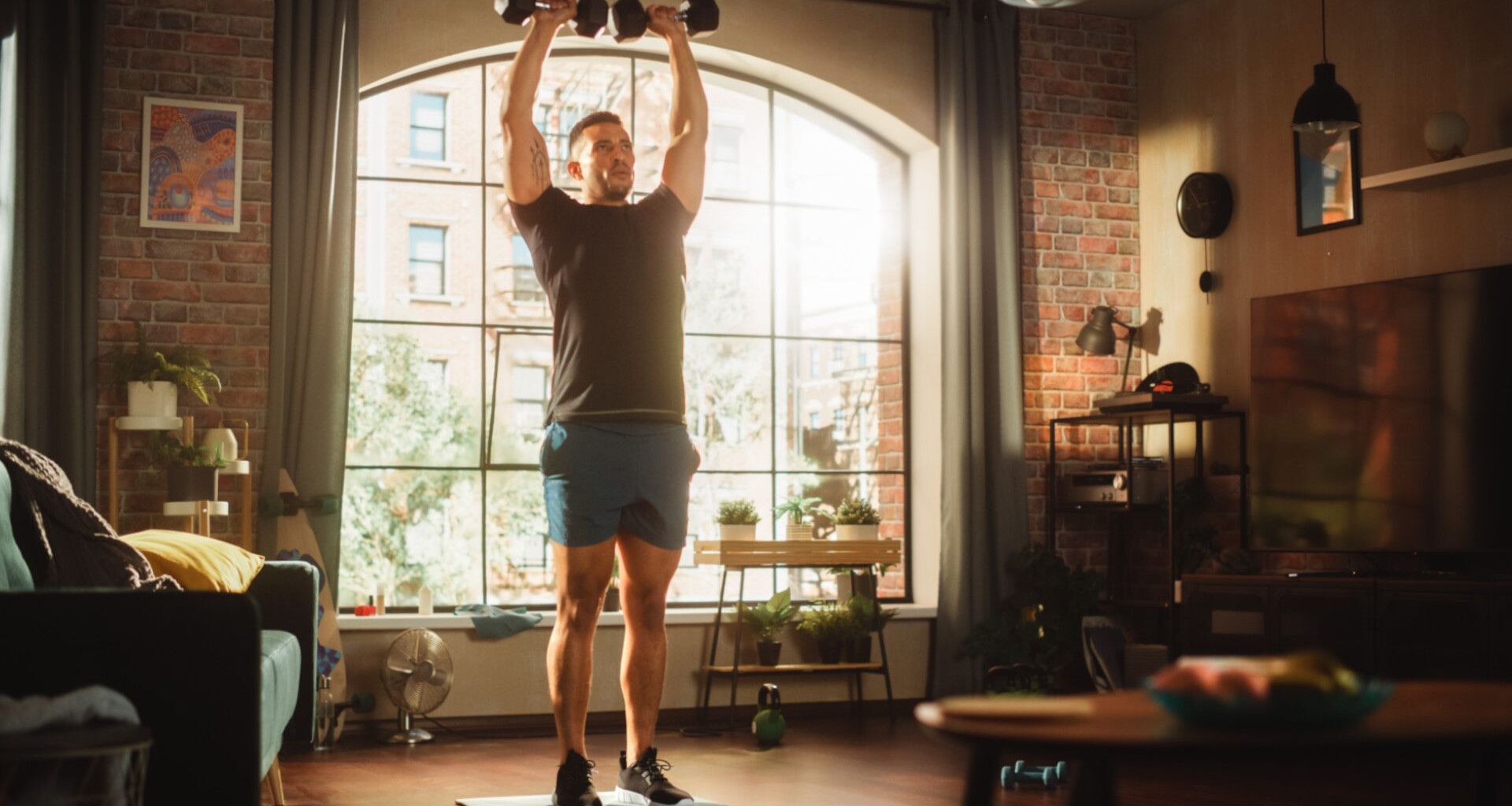 man doing dumbbell workout at home