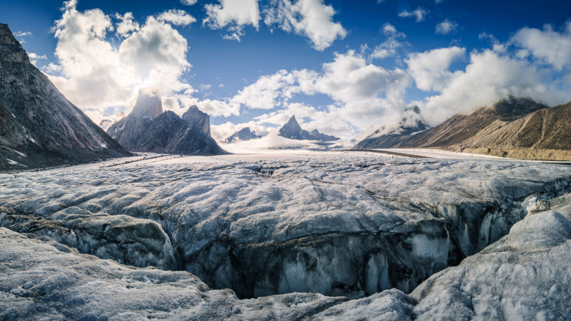 Image of sharp peaks sitting above a large glacier.