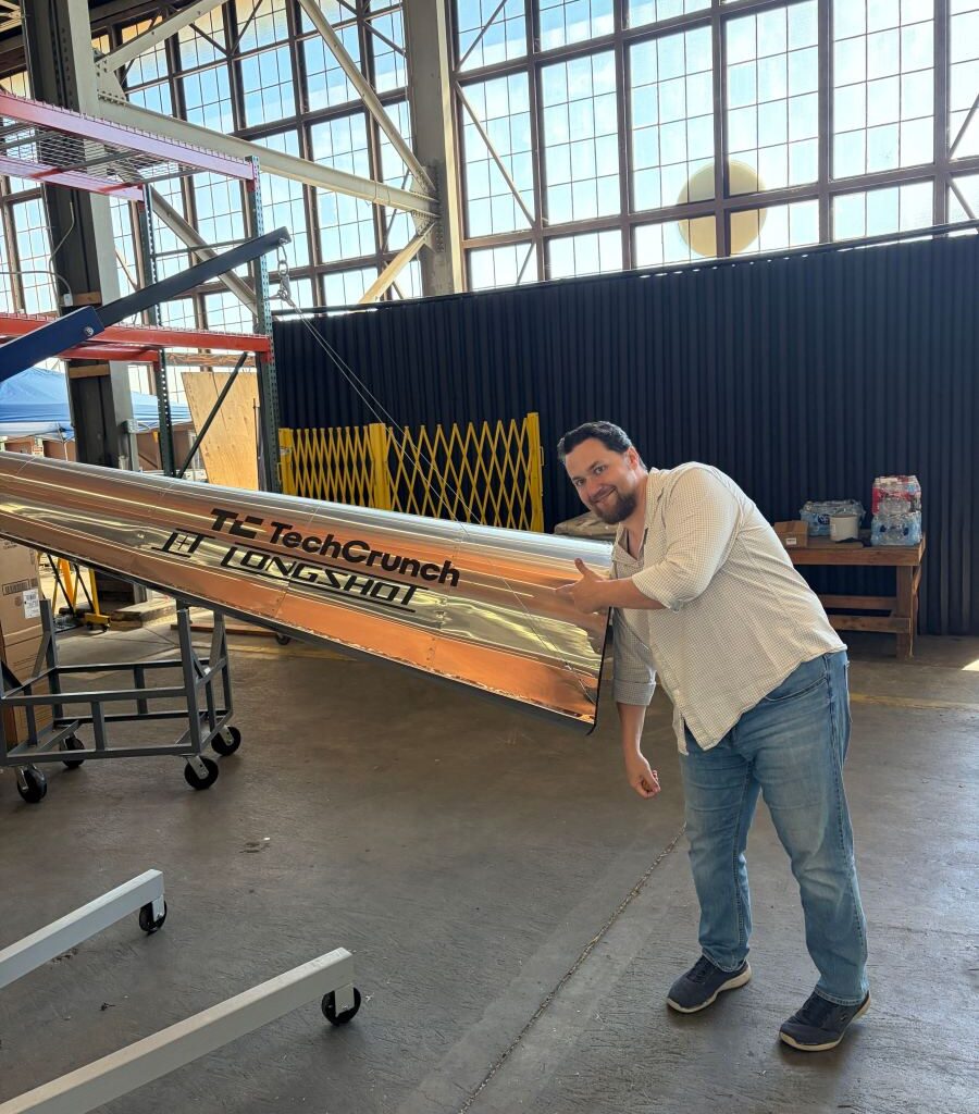 Longshot CEO and cofounder Mike Grace with a projectile designed to be fired from his company's enormous gun.