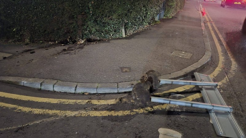 Irish-English language street sign ripped out of tarmac base