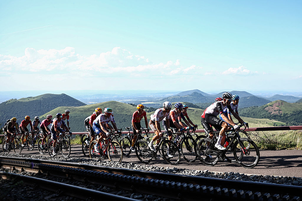 The pack of riders cycles in the ascent of the Puy de Dome in the final kilometers of the 9th stage of the 110th edition of the Tour de France cycling race, 182,5 km between Saint-Leonard-de-Noblat and Puy de Dome, in the Massif Central volcanic mountains in central France, on July 9, 2023. (Photo by Anne-Christine POUJOULAT / AFP)