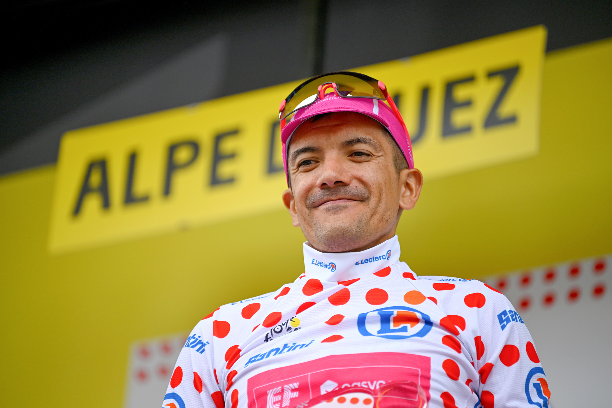 Richard Carapaz in the polka dot jersey on the podium after stage 20 of the 2026 Tour de France on L'Alpe d'Huez