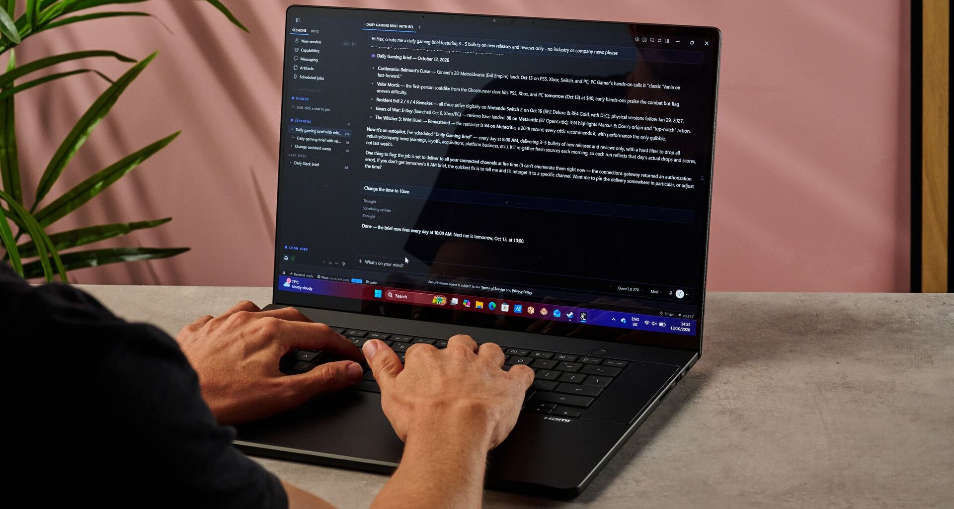 A man types into the Hermes hybrid AI agent app on the Asus ProArt P16 RTX Spark laptop.