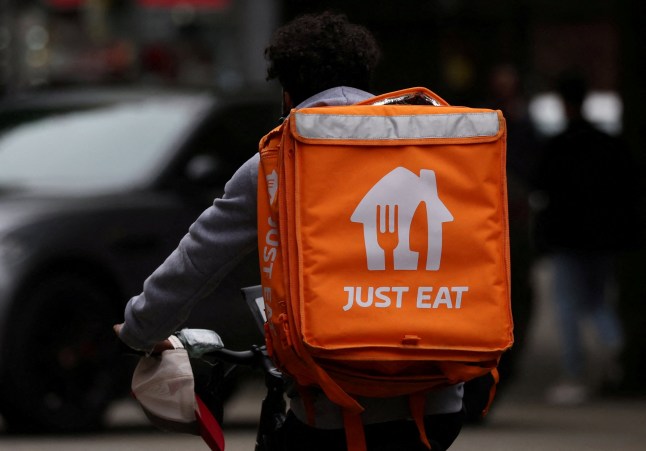 FILE PHOTO: A Just Eat delivery rider cycles through Manchester, Britain, August 23, 2023. REUTERS/Phil Noble/File Photo