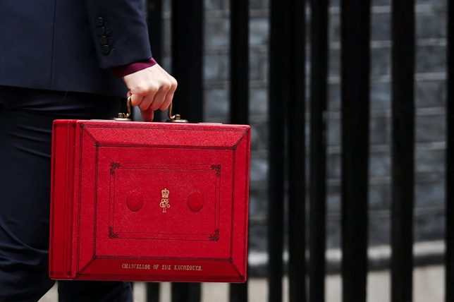 Britain's Chancellor of the Exchequer Rachel Reeves carries the red Budget Box as she leaves 11 Downing Street, in central London, on October 30, 2024, to present the government's annual Autumn budget to Parliament. Britain's new Labour government unveils its first budget on Wednesday, the highly-anticipated fiscal update, the first under the centre-left government after 14 years of Conservative rule. (Photo by Adrian Dennis / AFP) (Photo by ADRIAN DENNIS/AFP via Getty Images)