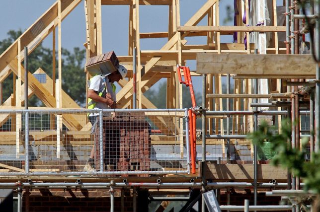 UNITED KINGDOM - JULY 01: A builder carries bricks, using a builder's hod on a house under construction on a Barratt residential development in Horley, Surrey, U.K., on Tuesday, July 1, 2008. Barratt Developments Plc, the U.K.'s worst performing homebuilder this year, plans to cut about 1,000 jobs as it closes and merges divisions. (Photo by Chris Ratcliffe/Bloomberg via Getty Images)