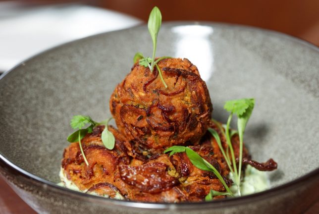 Science writer Clare Wilson trying food created with novel crops including Lupin Flour at the Blue Room Restaurant at University of Southampton. Onion bhaji made with lupin flour.