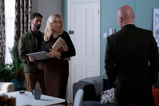Cindy stands with Rafael in Max's flat in EastEnders