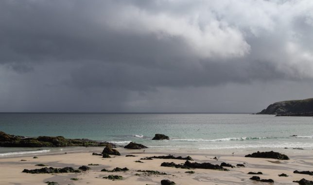 Landscape taken in Lewis with storm clouds and rain clouds in the sky. Beach in foreground